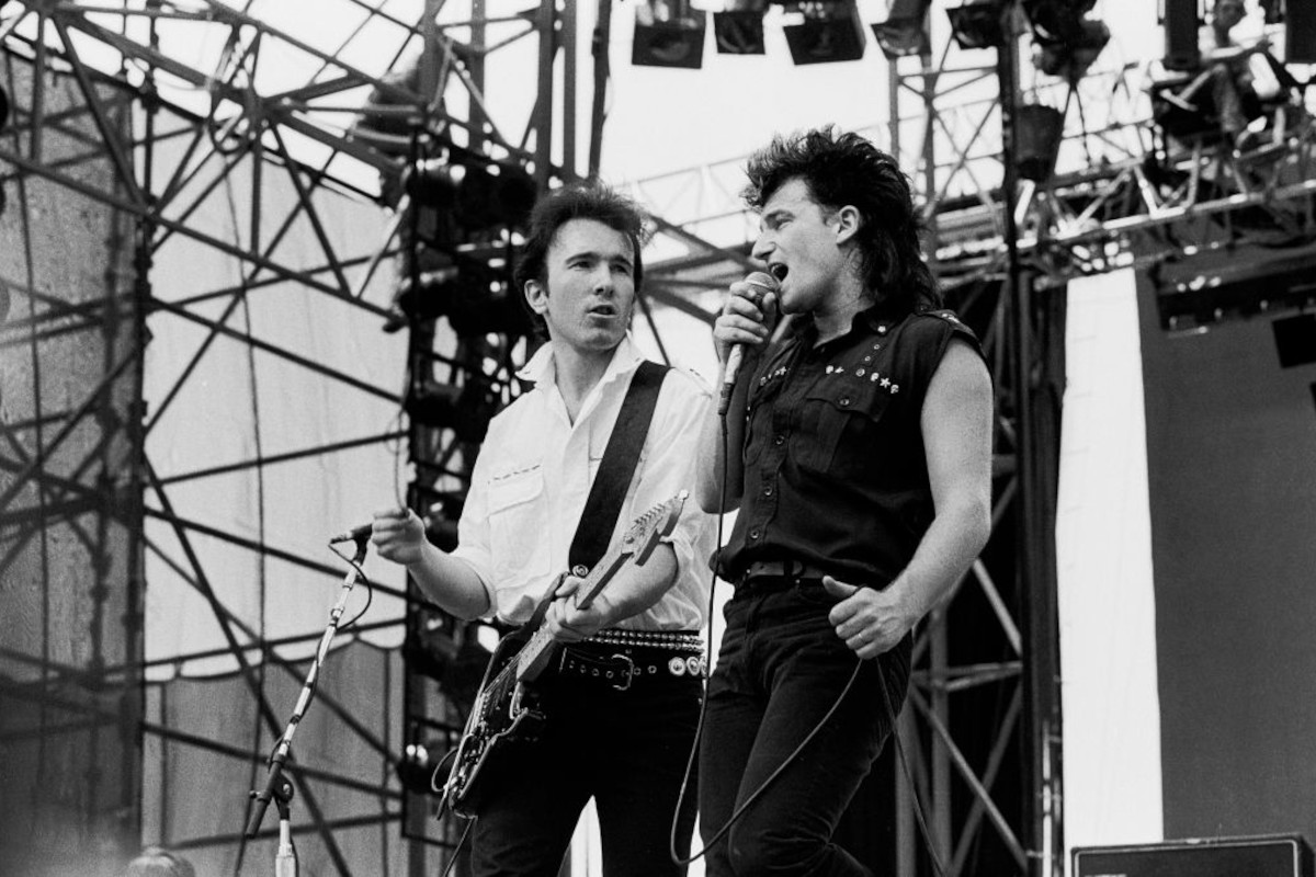 The Edge (left) and Bono performing with U2, 1983