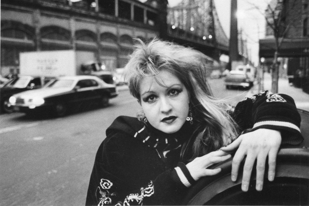Cyndi Lauper hangs out on the streets of Manhattan, New York with the 59th Street Bridge in the background on December 9, 1983