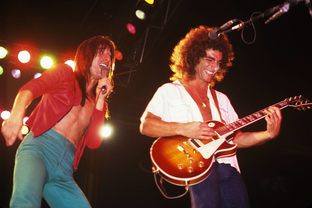 Steve Perry and Neal Schon of rock band Journey having a ball on stage, New York, 1980