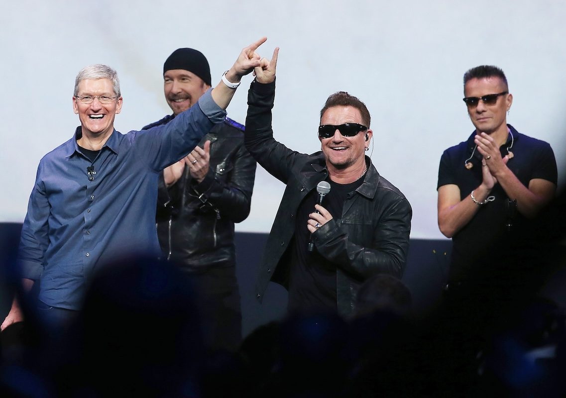 Bono and U2 hold microphone in front of crowd