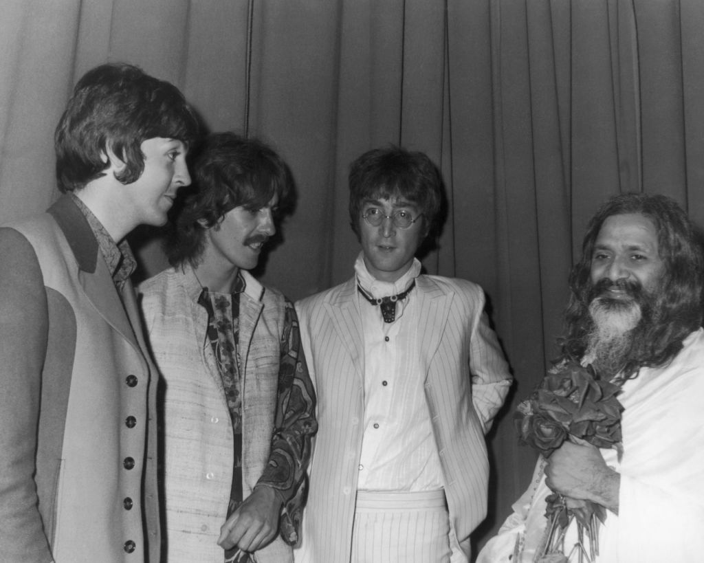 Paul McCartney, George Harrison and John Lennon of the Beatles, backstage with the Maharishi Mahesh Yogi after he gave a lecture on transcendental meditation at the Hilton hotel, London, August 25 1967