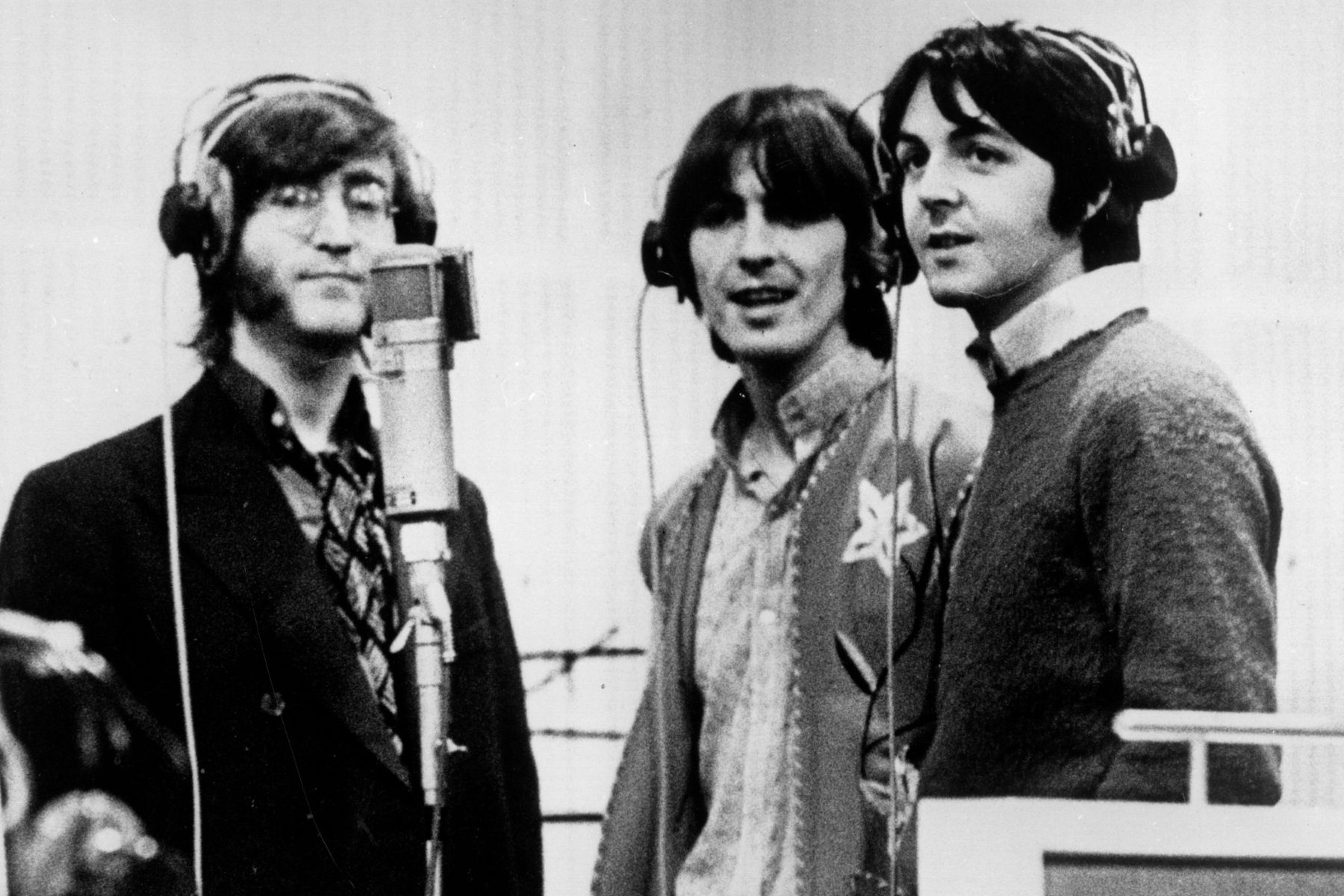 Three Beatles, from left to right John Lennon, George Harrison and Paul McCartney, record voices in a studio for their new cartoon film 'Yellow Submarine'
