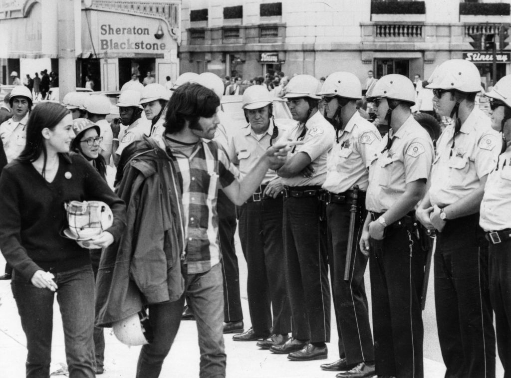 1968: A group of hippies taunting policemen during the trial of the Chicago Seven, a group of radicals arrested during the protests against the Vietnam war at the Democratic National Convention