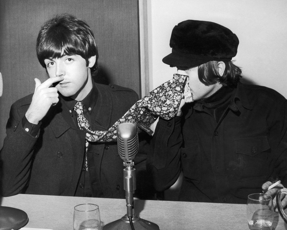 The Beatles' Paul McCartney and John Lennon pictured at a backstage news press conference at the Odeon, Glasgow, 3 Dec 1965. That day marked the start of their UK tour – and the release of their Rubber Soul album