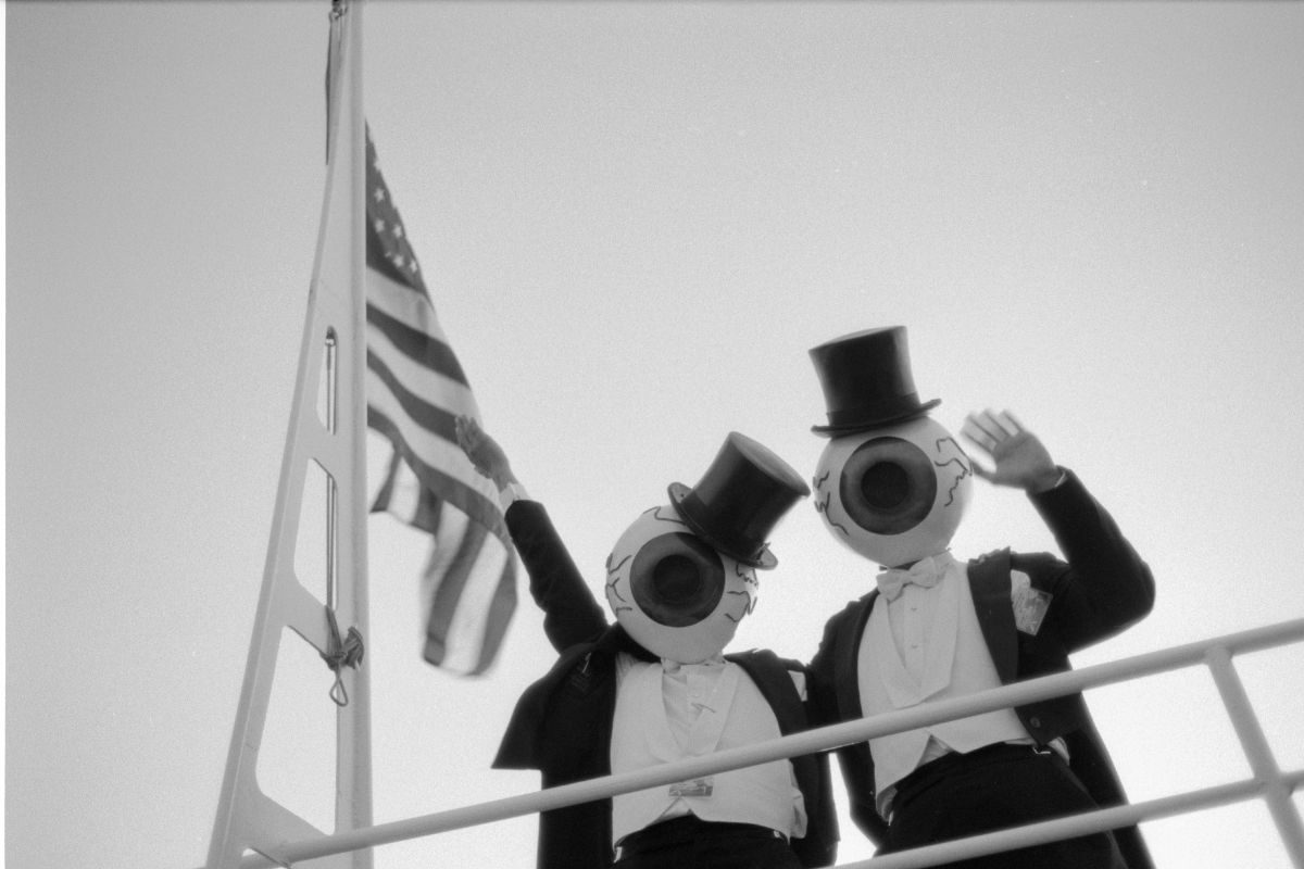 Members of the rock band the Residents wave from the Royal Star during an MTV boat party on San Francisco Bay, 1984