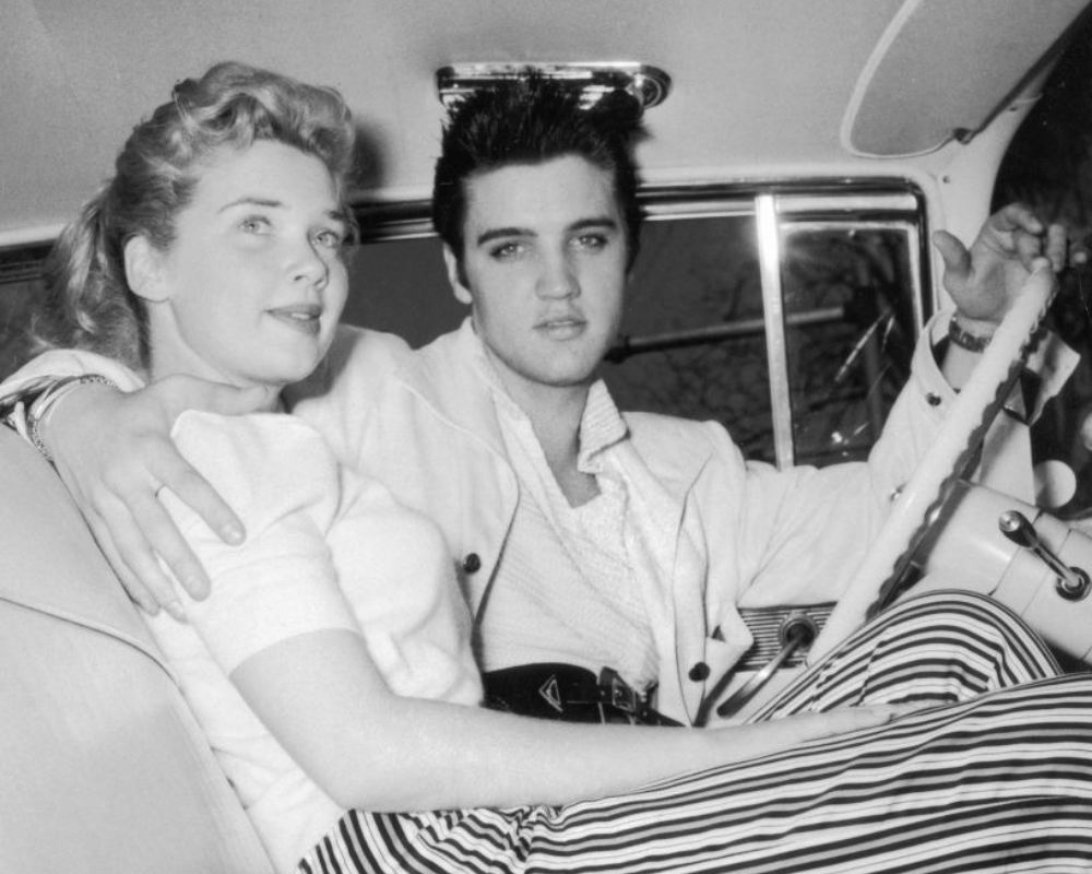 Elvis Presley and friend behind the wheel, 1955